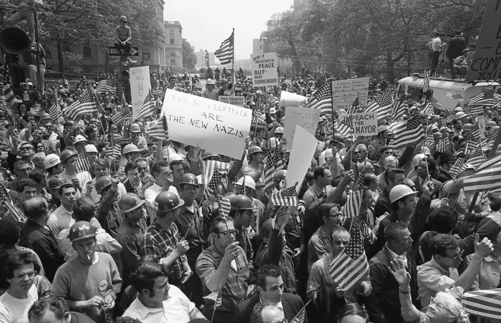 Demonstrators marched with American flags during the Hard Hat Riot in New York City in May 1970. Working-class, pro-American demonstrators clashed with anti-Vietnam War protesters. More than 100 people were injured.